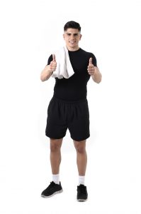 young attractive fit sport man holding towel on shoulder